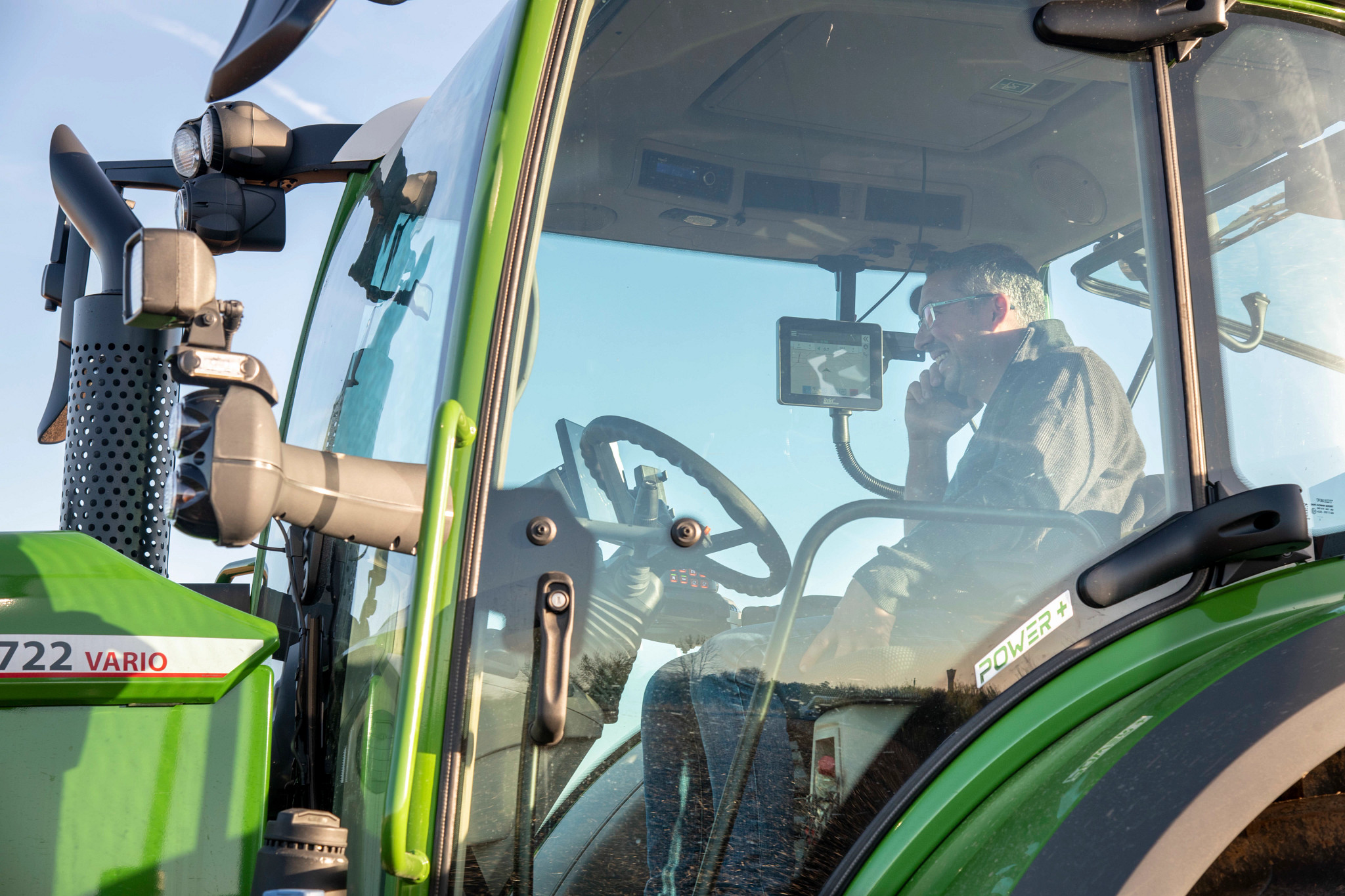 Farmer on a mobile phone in tractor